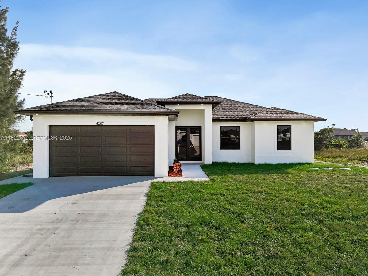 a front view of a house with a garden and yard
