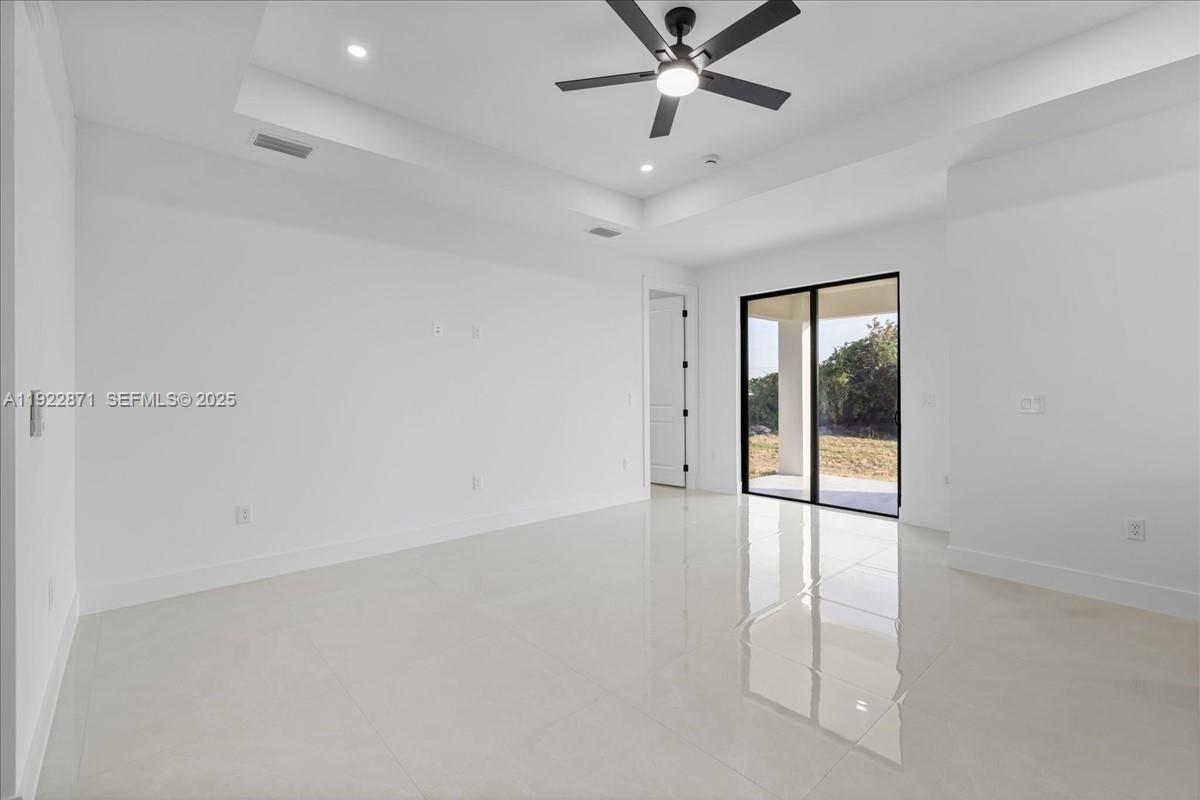 4207 28th Street Southwest Lehigh Acres, FL 33976 - Photo 16 of 39 an empty room with fan and windows