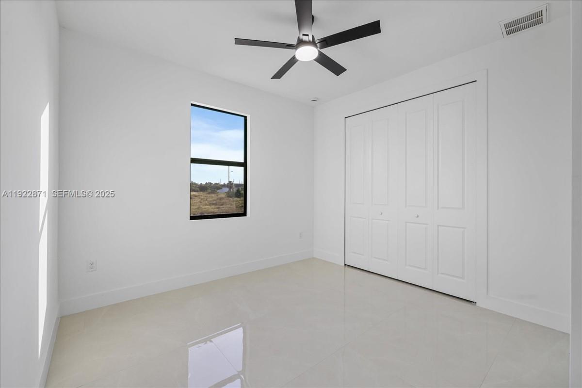 4207 28th Street Southwest Lehigh Acres, FL 33976 - Photo 23 of 39 a view of empty room with windows