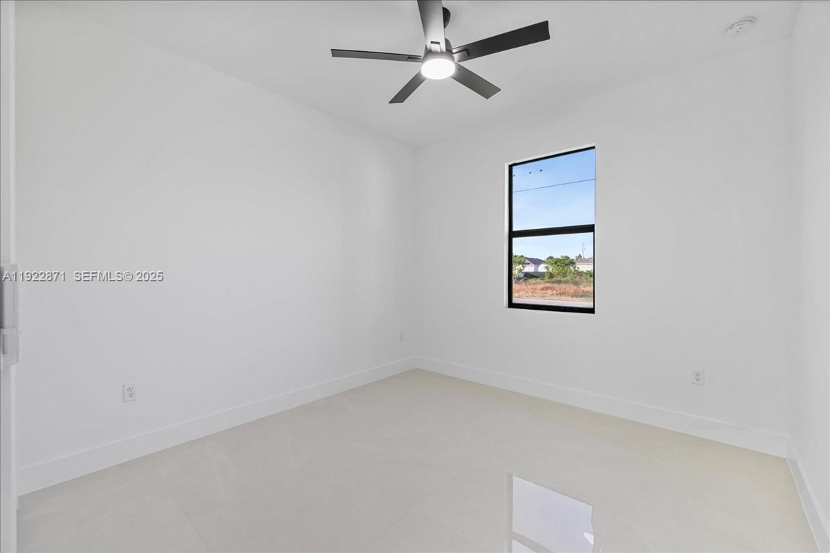 4207 28th Street Southwest Lehigh Acres, FL 33976 - Photo 24 of 39 an empty room with a window and a ceiling fan