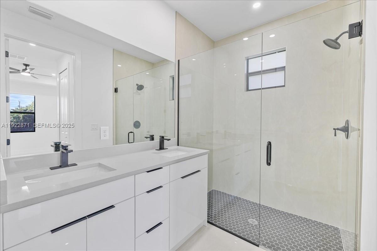 4207 28th Street Southwest Lehigh Acres, FL 33976 - Photo 26 of 39 a bathroom with a shower sink and mirror