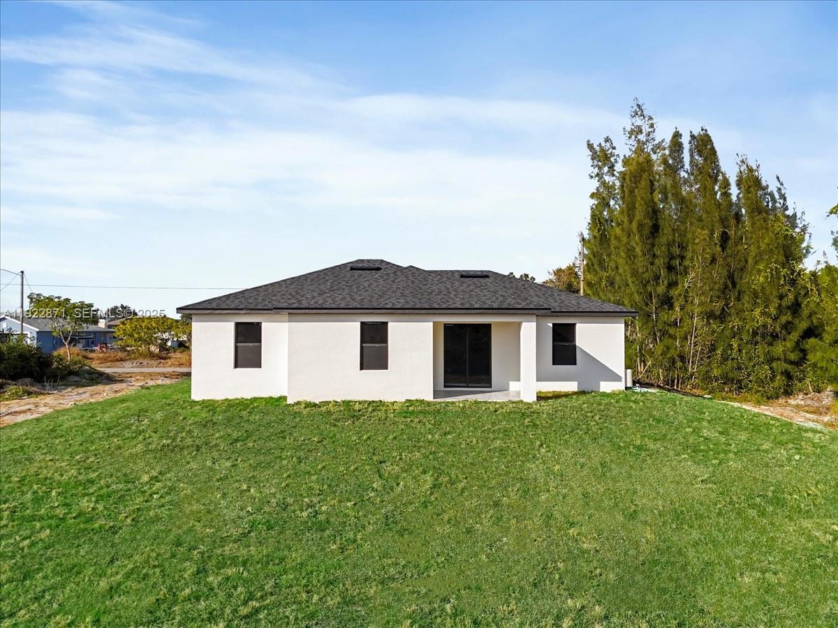 4207 28th Street Southwest Lehigh Acres, FL 33976 - Photo 30 of 39 a house that has a lot of windows in it