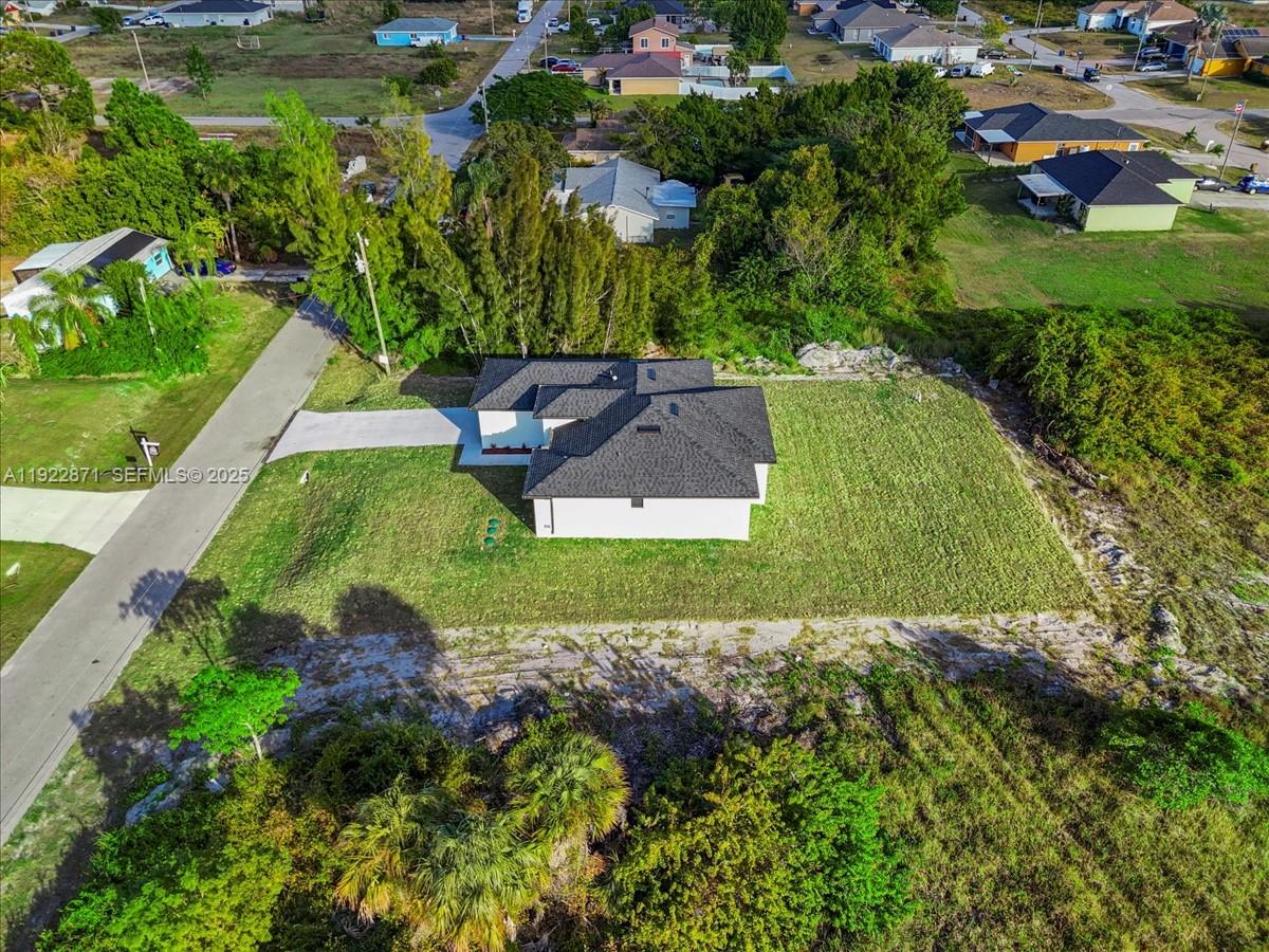 4207 28th Street Southwest Lehigh Acres, FL 33976 - Photo 35 of 39 an aerial view of a house with a yard