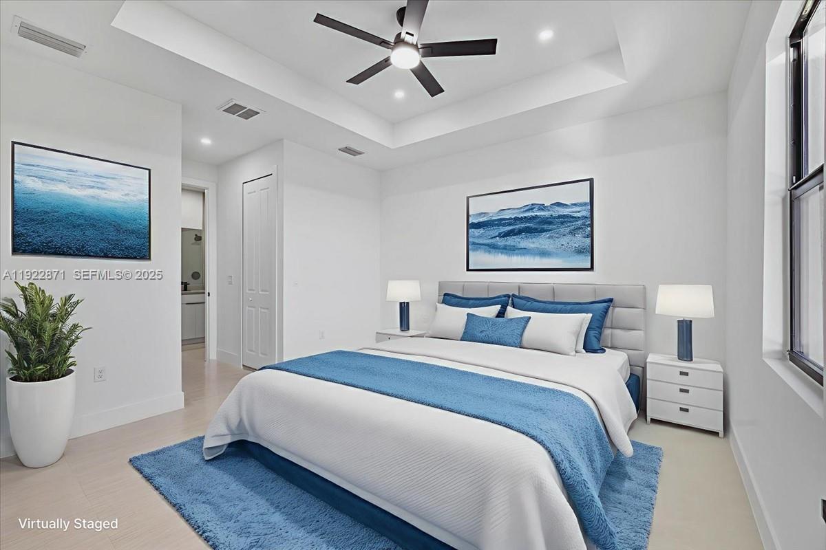 4207 28th Street Southwest Lehigh Acres, FL 33976 - Photo 4 of 39 a bedroom with a large bed and a potted plant