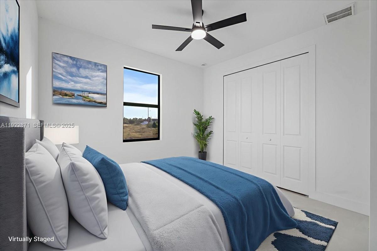 4207 28th Street Southwest Lehigh Acres, FL 33976 - Photo 5 of 39 a bedroom with a bed and a window