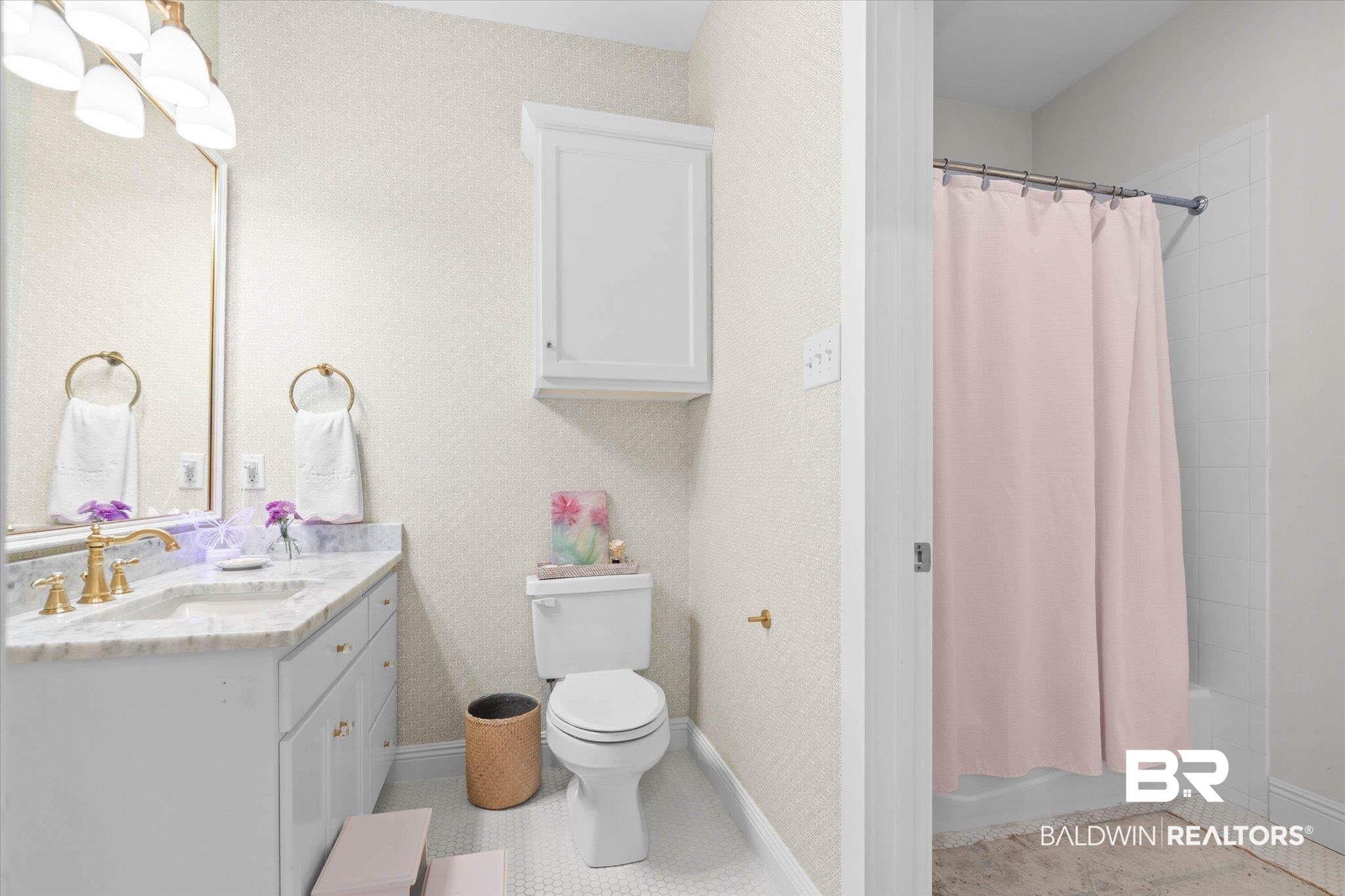 3813 Austill Lane Mobile, AL 36608 - Photo 20 of 37 Bathroom featuring a vanity with a light-colored countertop, an undermount sink, and brass-finish fixtures