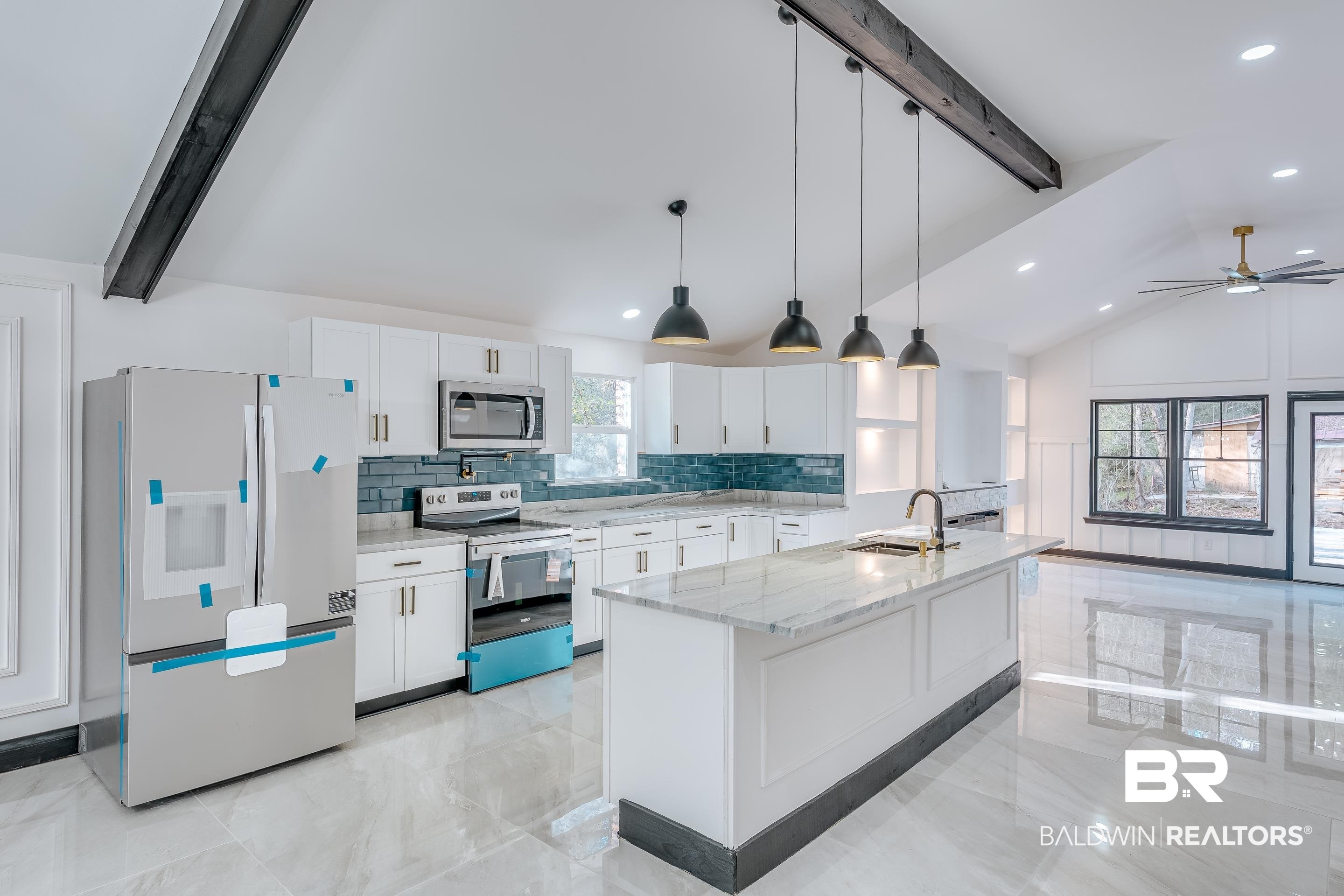 1190 Military Road Mount Vernon, AL 36560 - Photo 6 of 47 Kitchen featuring beamed ceiling, appliances with stainless steel finishes, decorative light fixtures, light stone countertops, and white cabinetry