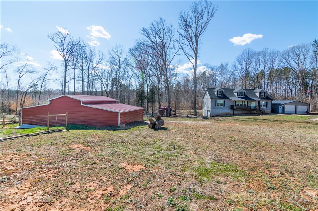 740 Renshaw Ford Road, Unit 5 Woodleaf, NC 27054 - Photo 1 of 30 a small garden covered with tall trees