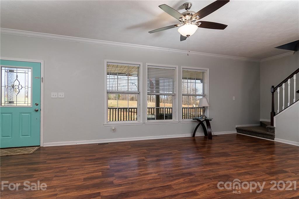 740 Renshaw Ford Road, Unit 5 Woodleaf, NC 27054 - Photo 12 of 30 a view of empty room with wooden floor and fan
