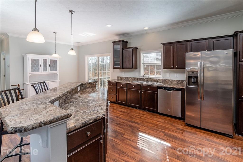 740 Renshaw Ford Road, Unit 5 Woodleaf, NC 27054 - Photo 14 of 30 a large kitchen with granite countertop counter space a sink and appliances