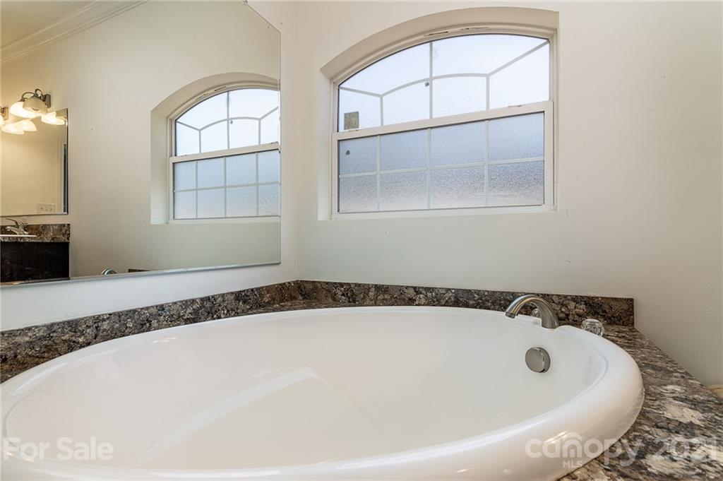 740 Renshaw Ford Road, Unit 5 Woodleaf, NC 27054 - Photo 20 of 30 a bathroom with a bathtub and a window