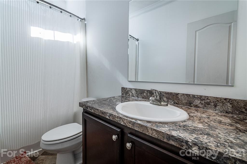 740 Renshaw Ford Road, Unit 5 Woodleaf, NC 27054 - Photo 22 of 30 a bathroom with a granite countertop sink and a toilet
