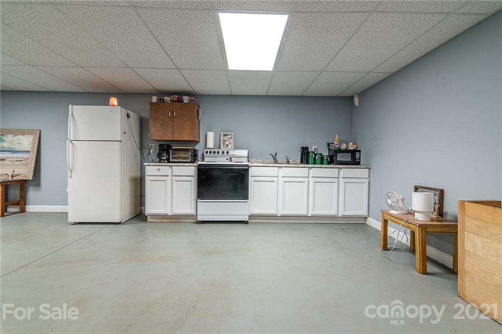 740 Renshaw Ford Road, Unit 5 Woodleaf, NC 27054 - Photo 27 of 30 a kitchen with cabinets and white appliances