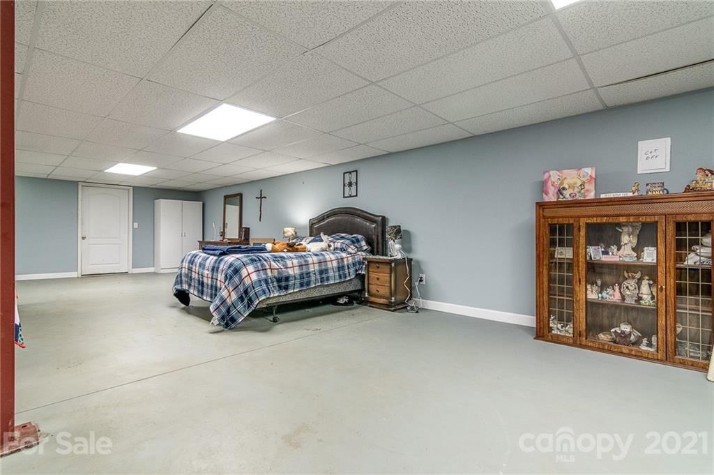 740 Renshaw Ford Road, Unit 5 Woodleaf, NC 27054 - Photo 28 of 30 a bed room with a bed and a tv