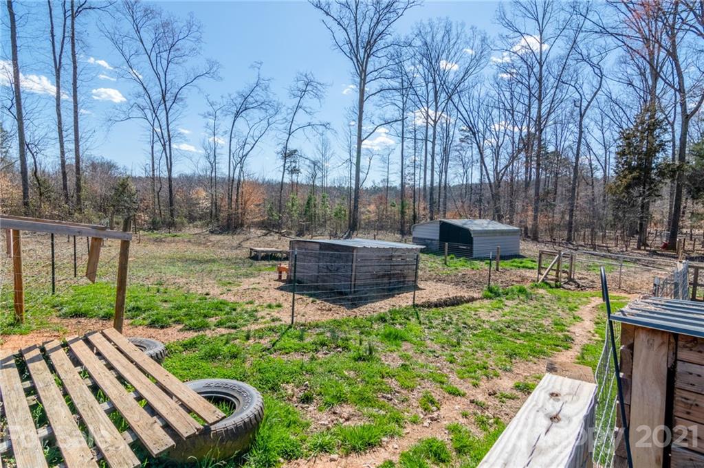 740 Renshaw Ford Road, Unit 5 Woodleaf, NC 27054 - Photo 7 of 30 a view of a backyard with couches chair and a fire pit