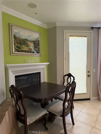 a dining room with furniture and a fireplace