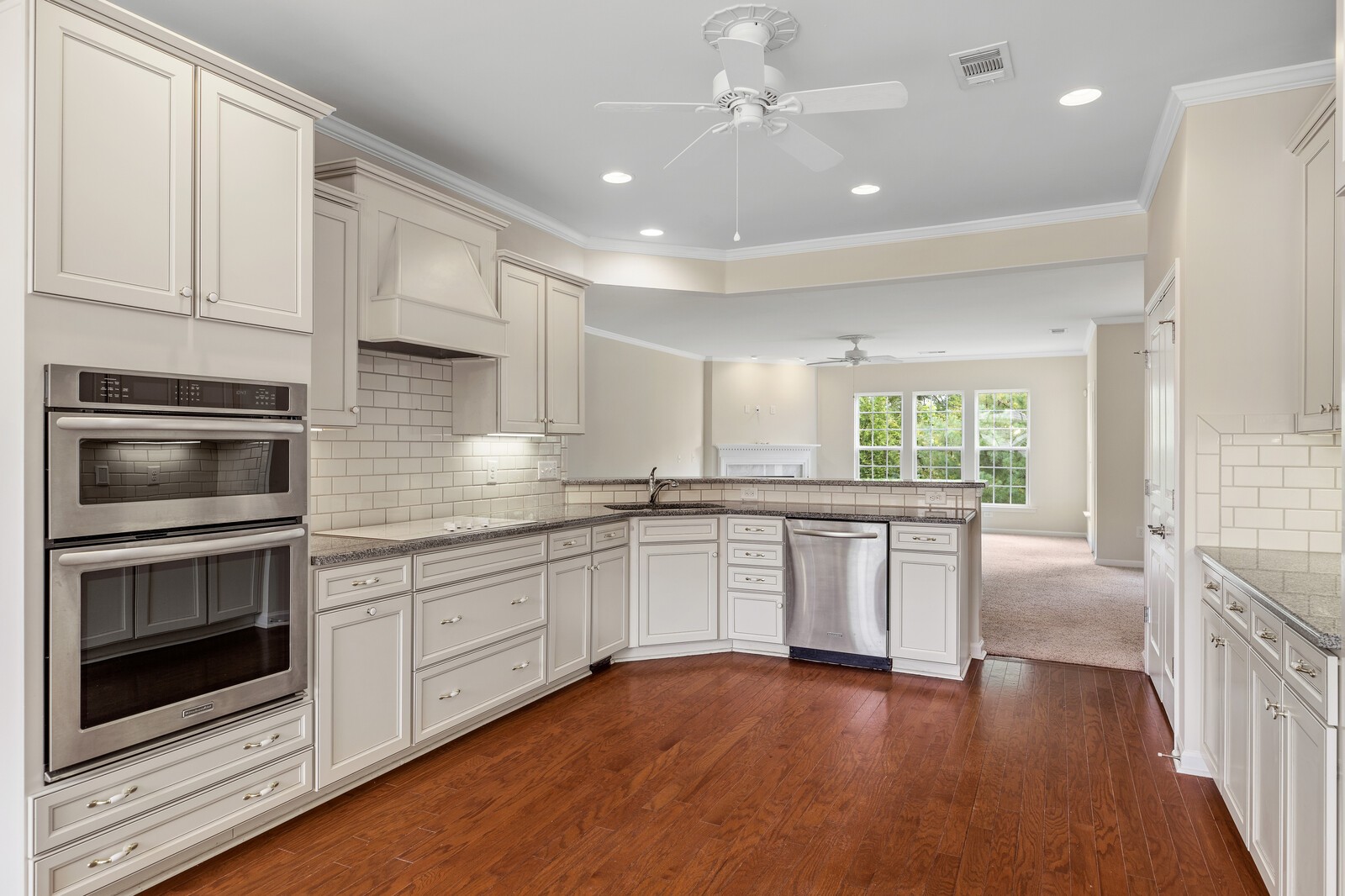 116 Dahlgren Drive Mount Juliet, TN 37122 - Photo 7 of 20 a kitchen with stainless steel appliances granite countertop hardwood floor sink stove and white cabinets