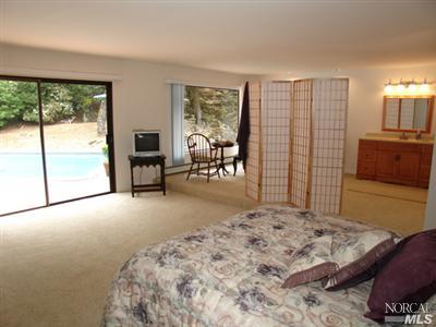 1696 Happy Valley Road Santa Rosa, CA 95404 - Photo 8 of 9 a bedroom with a bed and a large window with balcony view
