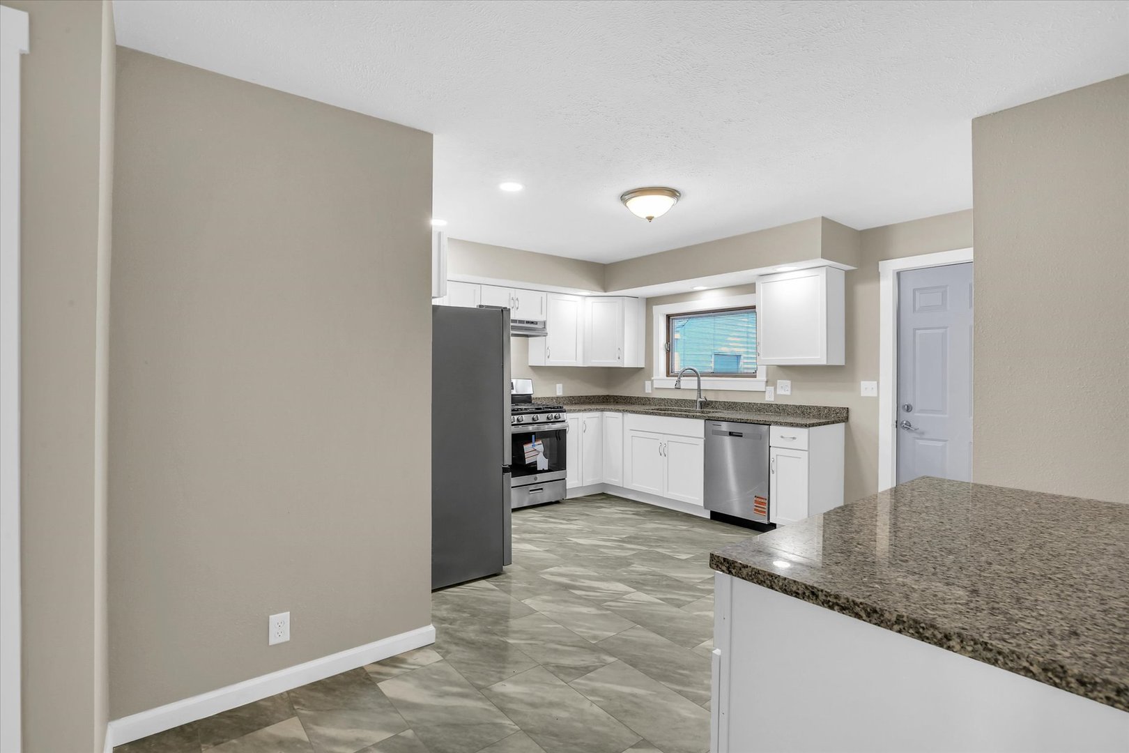 305 East Main Street Ogden, IL 61859 - Photo 11 of 31 a kitchen with stainless steel appliances granite countertop a refrigerator sink and white cabinets