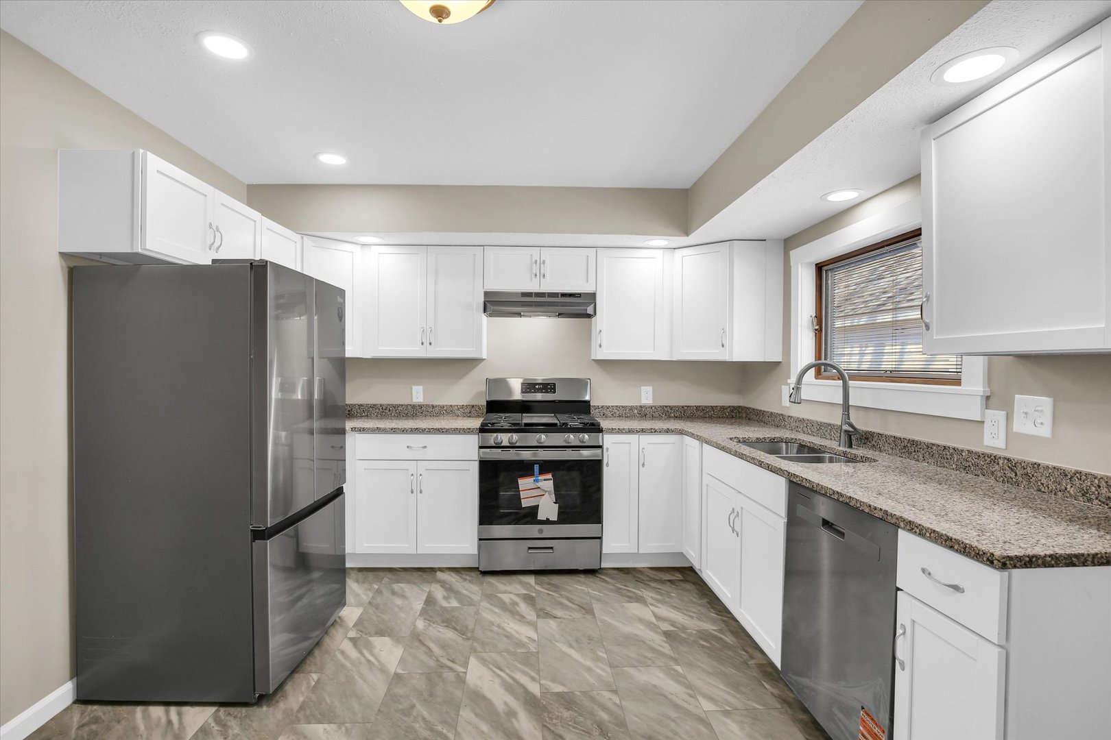 305 East Main Street Ogden, IL 61859 - Photo 13 of 31 a kitchen with stainless steel appliances granite countertop a stove a refrigerator and a sink