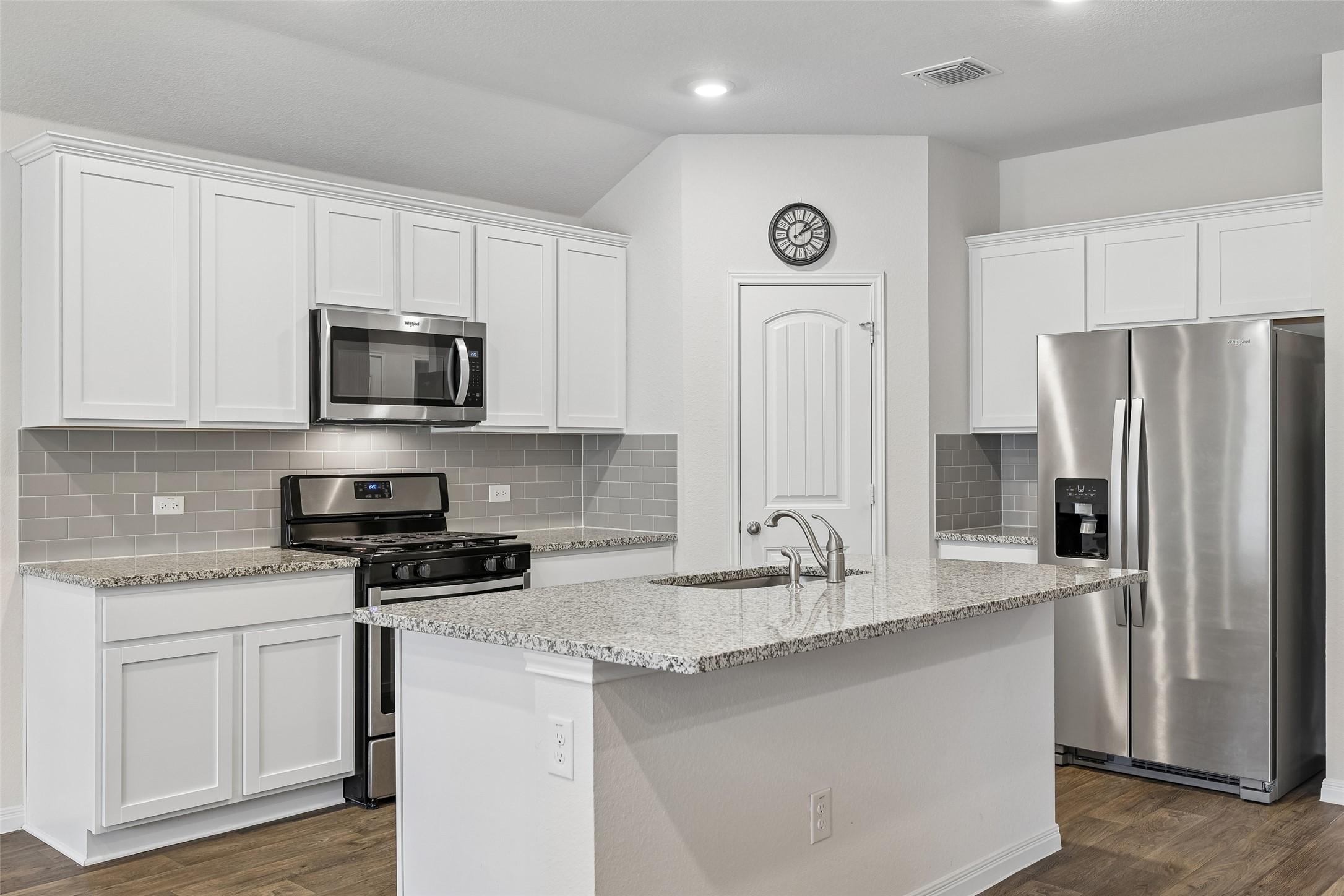 19805 Abigail Fillmore Road Manor, TX 78653 - Photo 11 of 40 Culinary delights await in this bright kitchen with granite counters and contemporary stainless steel appliances.