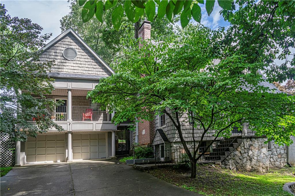 front view of a house with a tree
