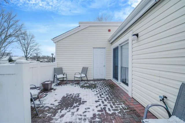a view of a pathway of a house with yard and potted plants