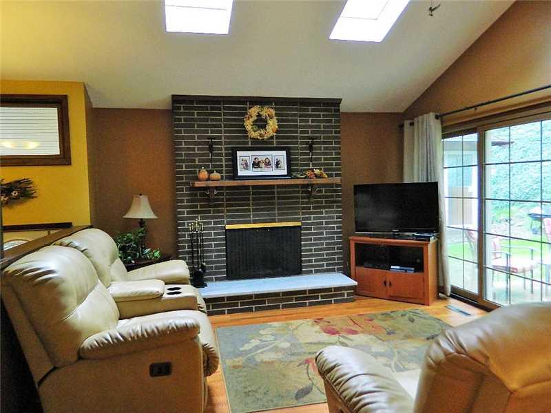 145 Byron Road Pittsburgh, PA 15237 - Photo 3 of 22 Living Room. The Bright Living Room has Cathedral Ceilings, two Skylights, Log Burning Fireplace, Hardwood Flooring and a new Sliding Glass Door leading to the Rear Yard.