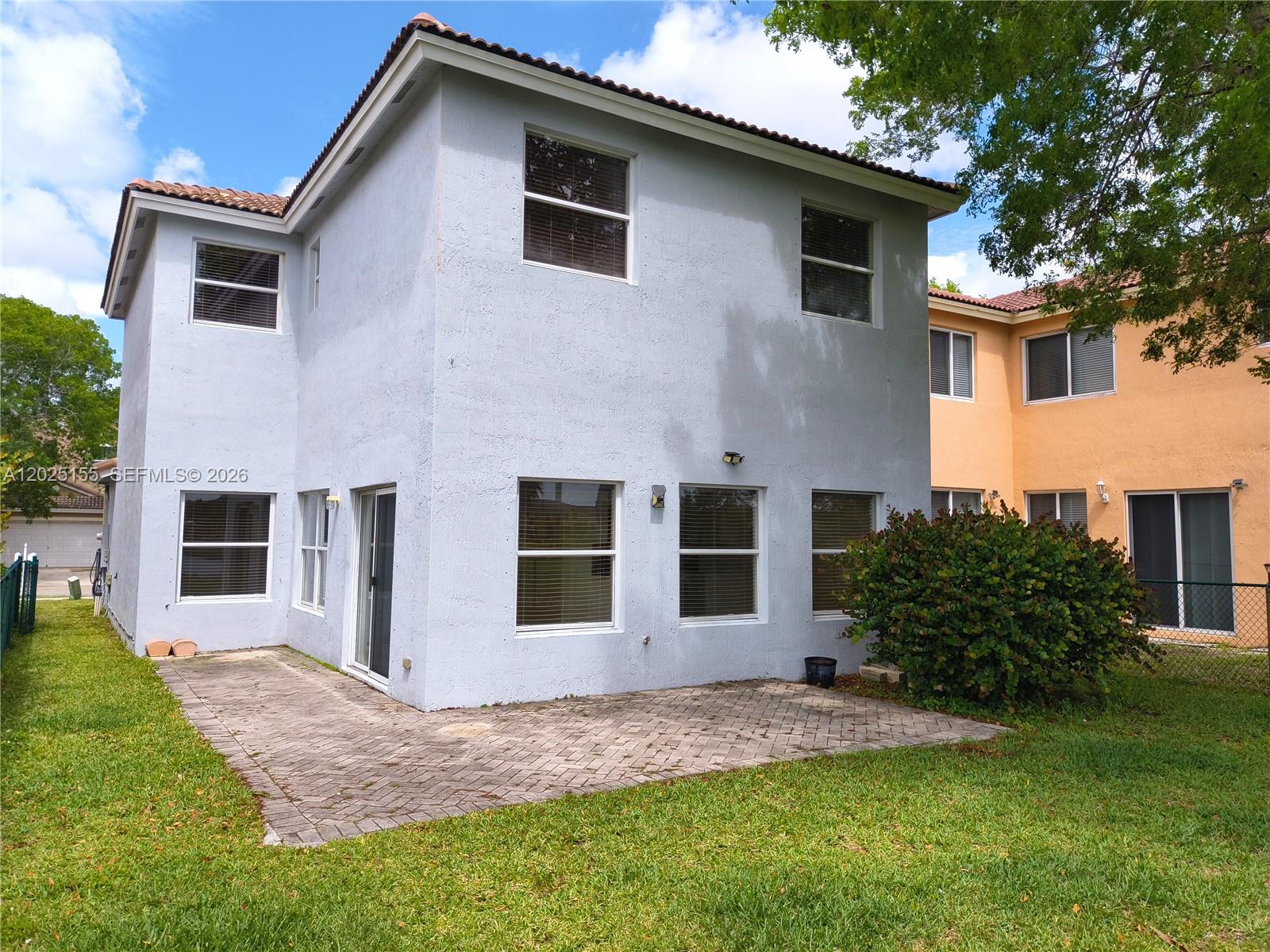 1645 Southeast 20th Road, Unit 1645 Homestead, FL 33035 - Photo 19 of 20 a front view of a house with a garden and yard