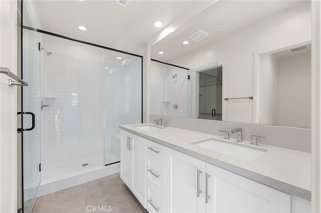 19011 Main Street, Unit 101 Huntington Beach, CA 92648 - Photo 28 of 36 a bathroom with a double vanity sink mirror double and shower