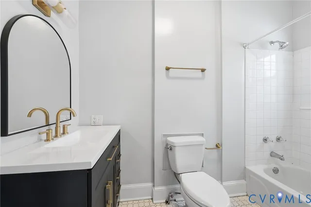 a bathroom with a sink vanity mirror and toilet