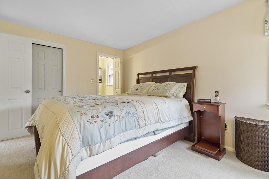 54 Joyce Road Framingham, MA 01701 - Photo 22 of 42 a spacious bedroom with a bed and a night stand