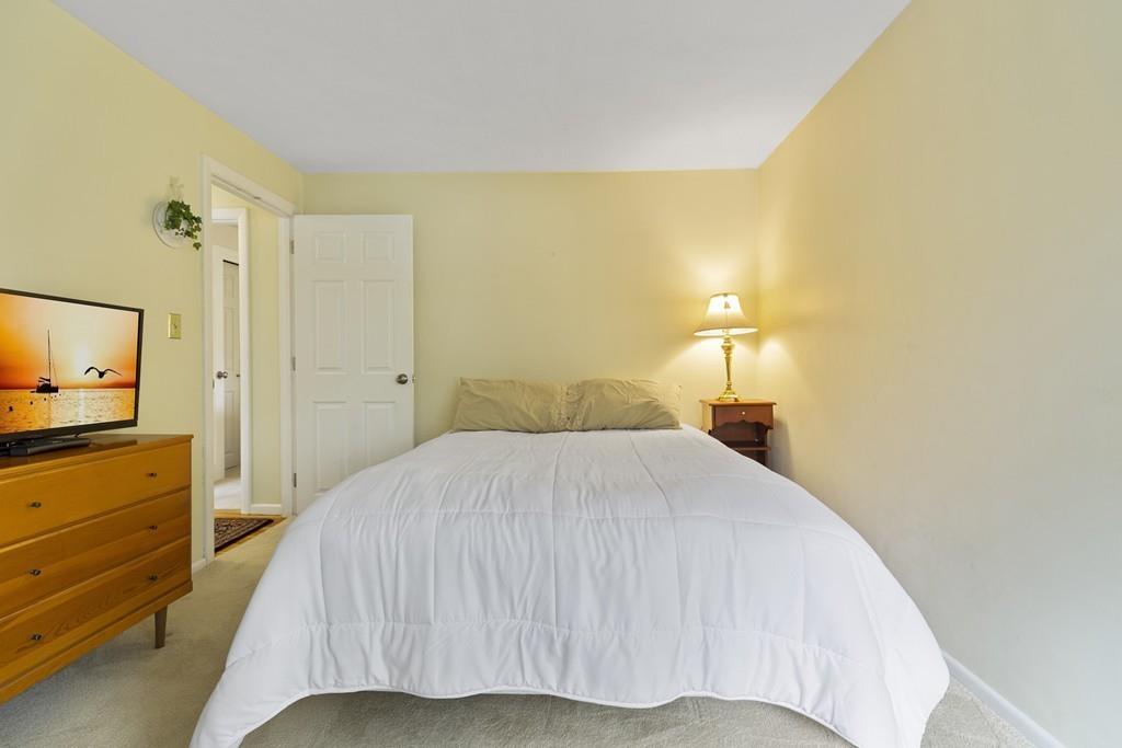 54 Joyce Road Framingham, MA 01701 - Photo 25 of 42 a bedroom with a bed and a flat tv screen on dresser