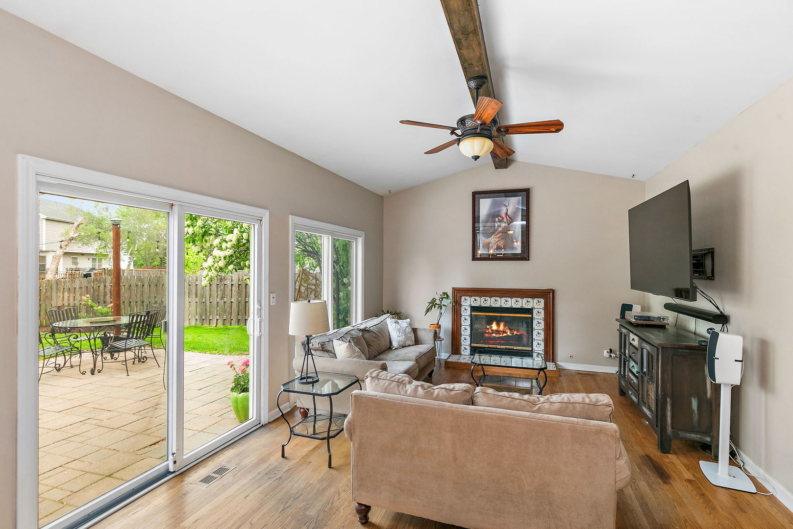 112 Thompson Boulevard Buffalo Grove, IL 60089 - Photo 13 of 34 a living room with furniture a flat screen tv and a floor to ceiling window