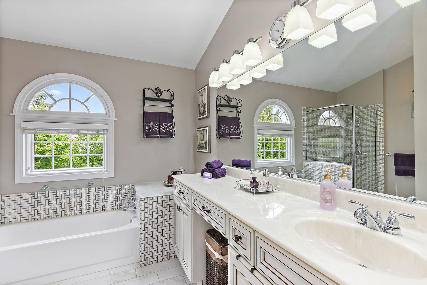 112 Thompson Boulevard Buffalo Grove, IL 60089 - Photo 19 of 34 a bathroom with a granite countertop sink a large mirror a bathtub and a window