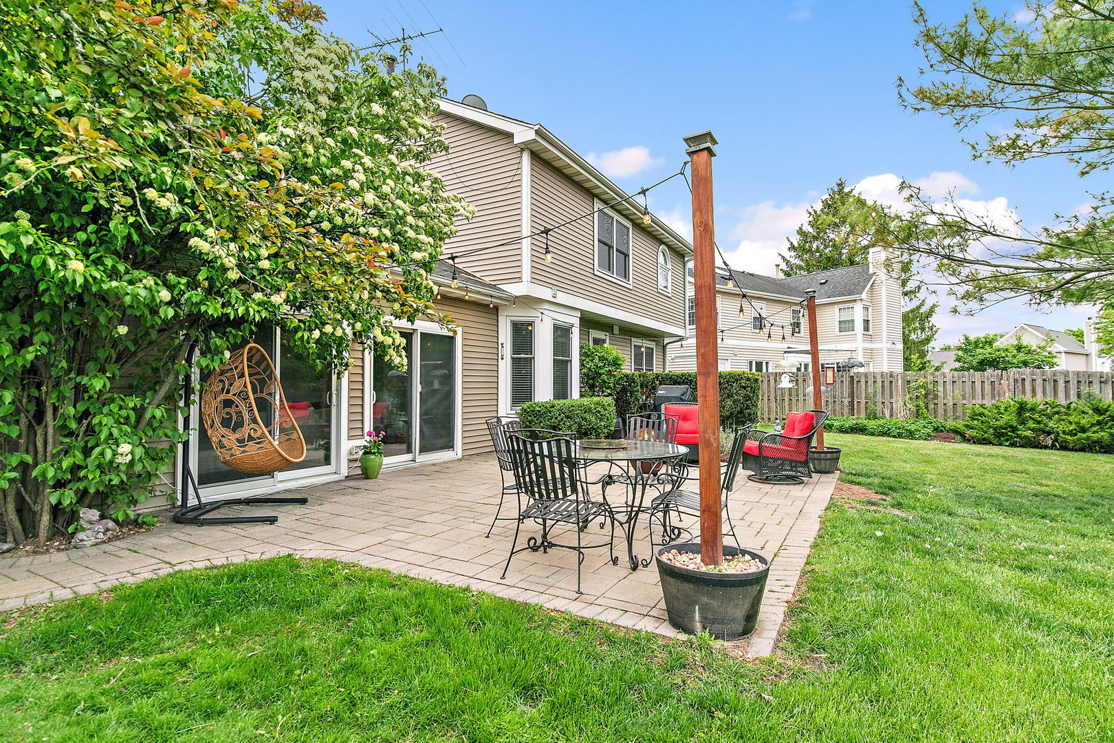 112 Thompson Boulevard Buffalo Grove, IL 60089 - Photo 29 of 34 a view of a house with backyard sitting area and garden