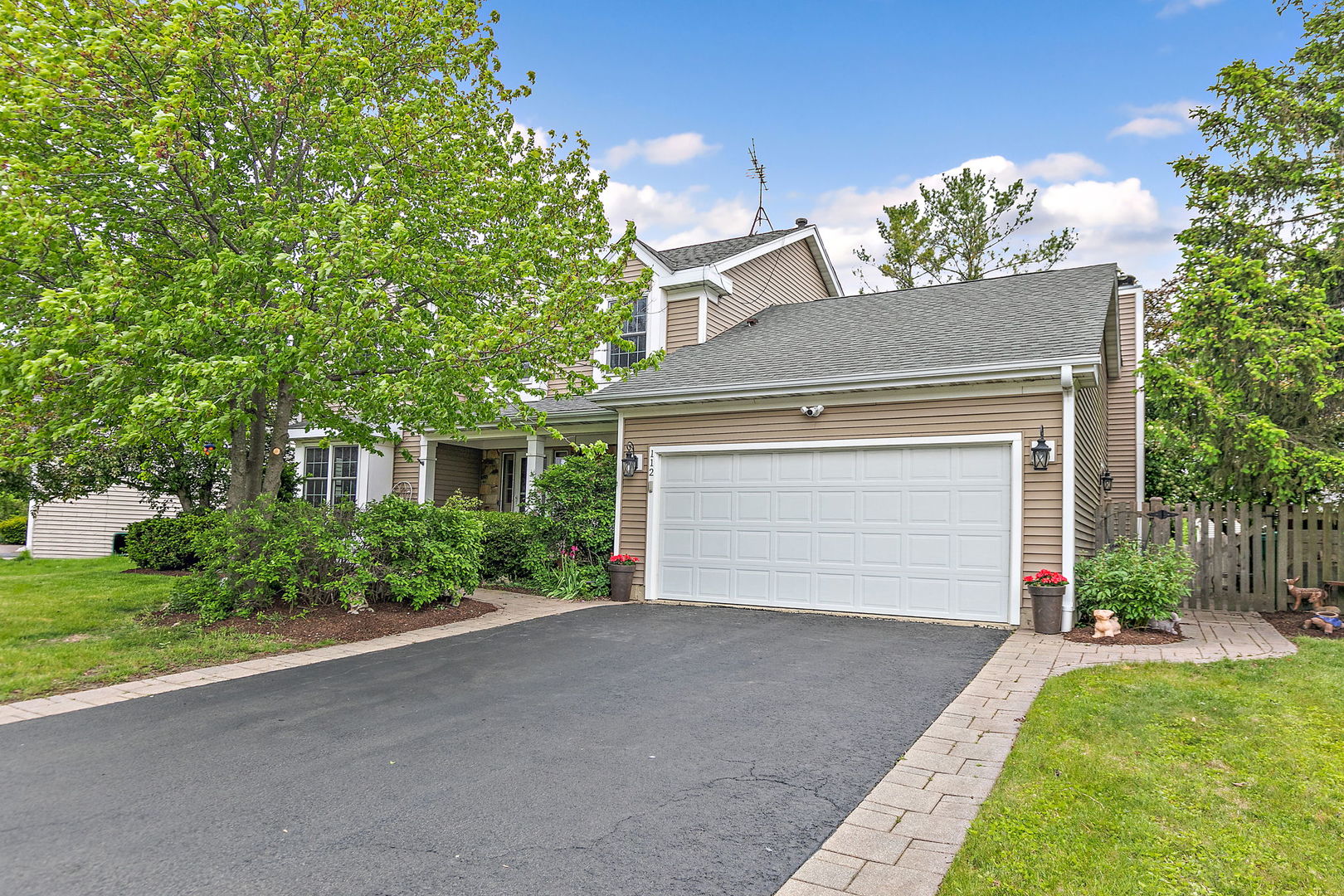 112 Thompson Boulevard Buffalo Grove, IL 60089 - Photo 33 of 34 a front view of a house with a yard and garage