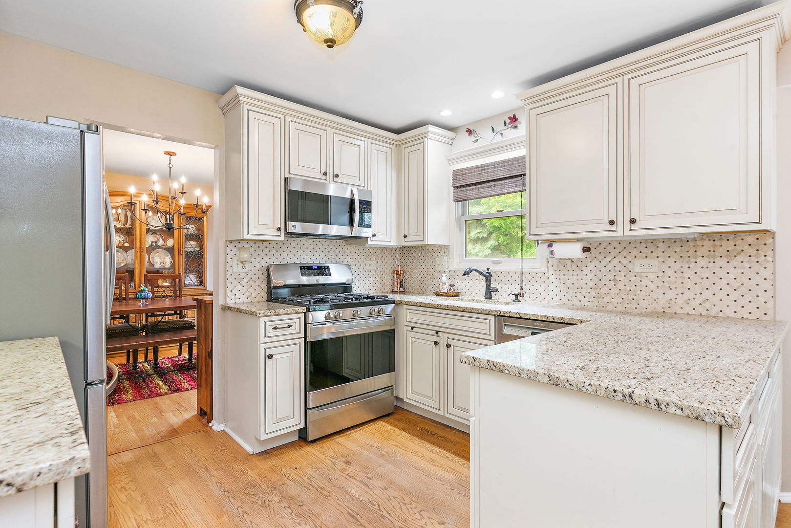 112 Thompson Boulevard Buffalo Grove, IL 60089 - Photo 9 of 34 a kitchen with stainless steel appliances granite countertop a stove a sink and a microwave