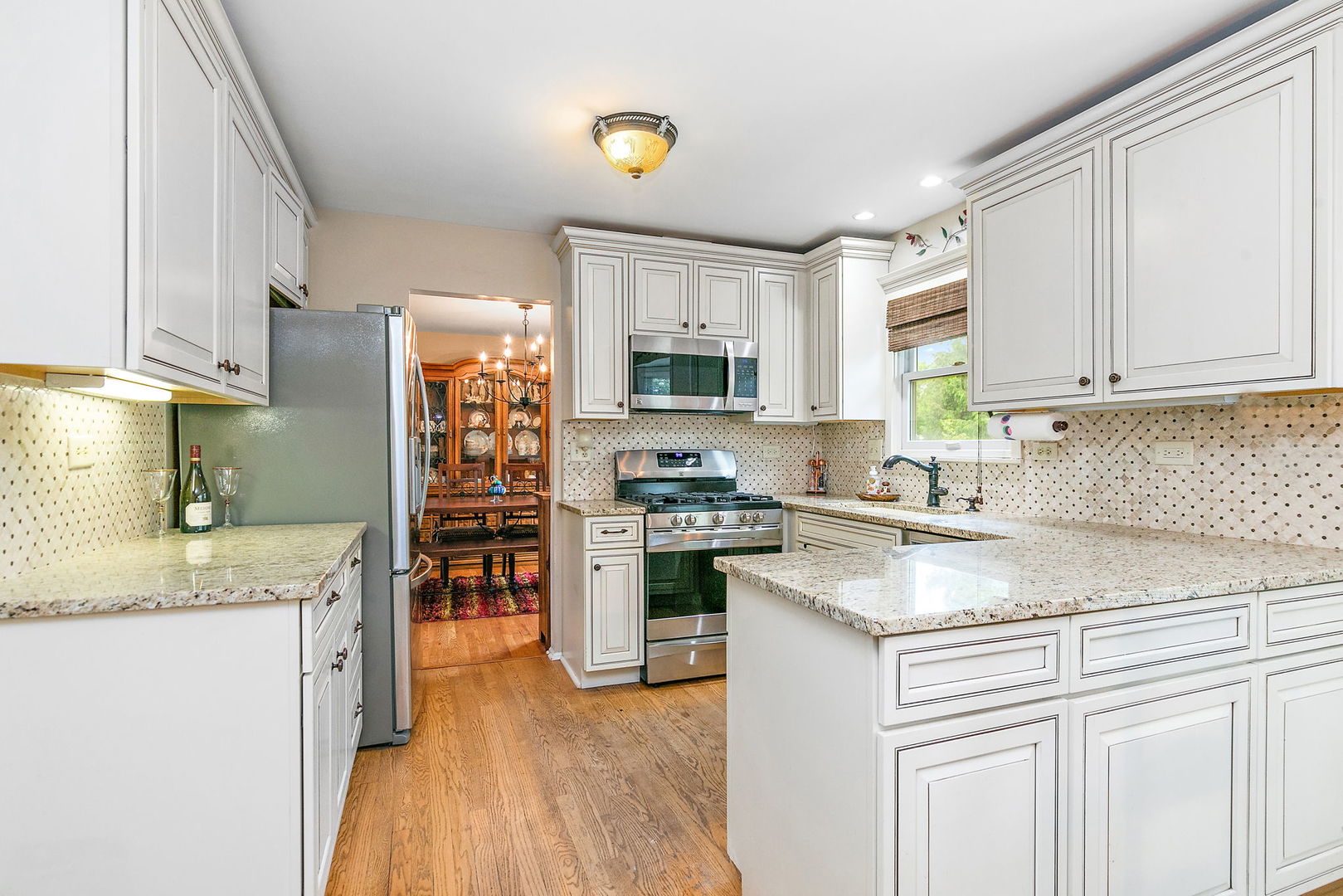 112 Thompson Boulevard Buffalo Grove, IL 60089 - Photo 10 of 34 a kitchen with stainless steel appliances granite countertop a sink stove microwave and refrigerator