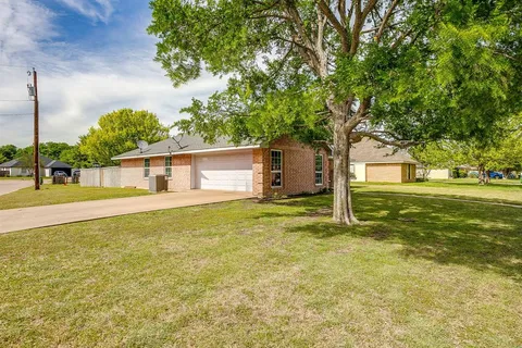 a house view with a trees in the background