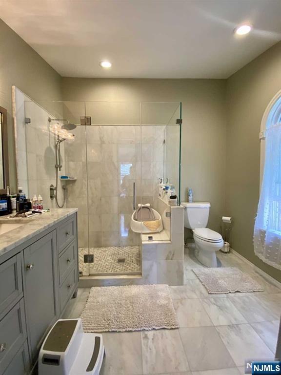 144 Panorama Drive Edgewater, NJ 07020 - Photo 3 of 10 a bathroom with a double vanity sink toilet and shower