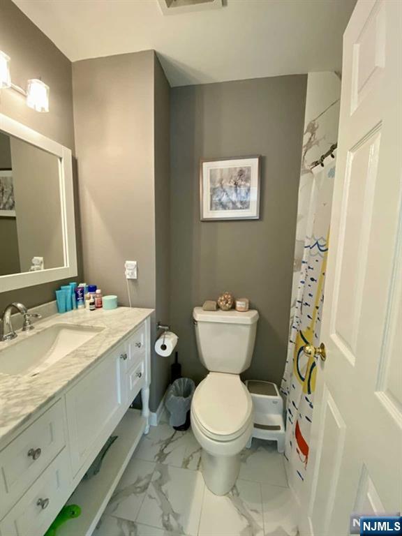 144 Panorama Drive Edgewater, NJ 07020 - Photo 5 of 10 a bathroom with a toilet sink and mirror