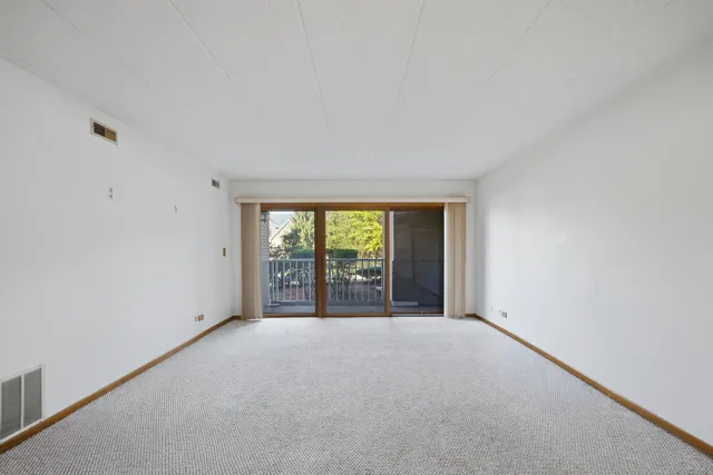 a view of an empty room with a balcony
