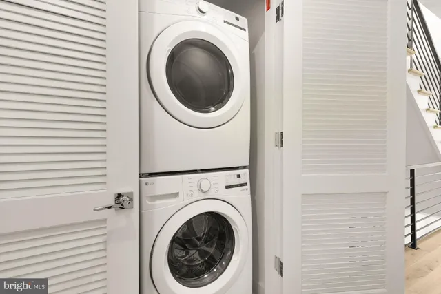 a view of a hallway with washer and dryer