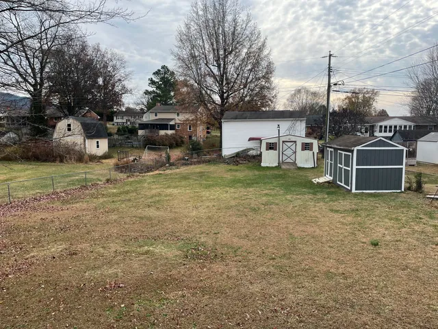 a view of a house with a yard and sitting area