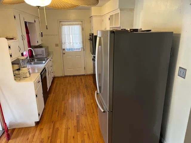 a view of a kitchen from the hallway
