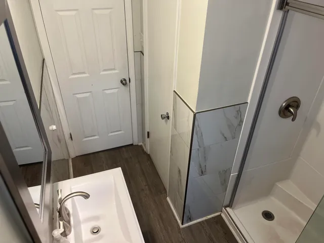 a bathroom with a tub and shower