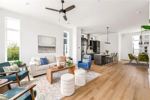 a living room with furniture and a wooden floor