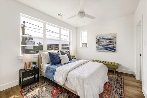 a bedroom with a bed and wooden floor