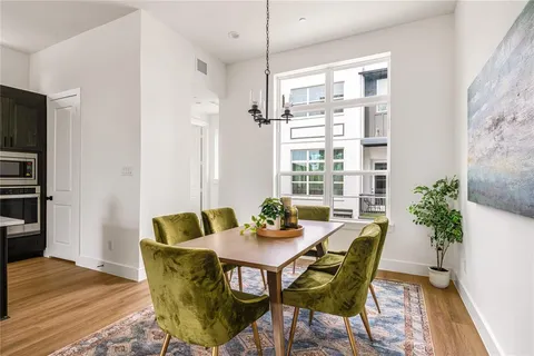 a view of a dining room with furniture window and wooden floor